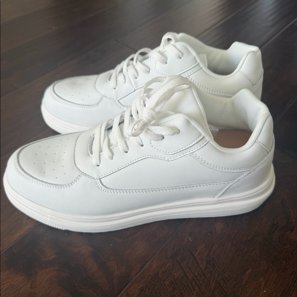 Height-enhancing shoes. These white sneakers add around 2.3-2.6 inches of height
